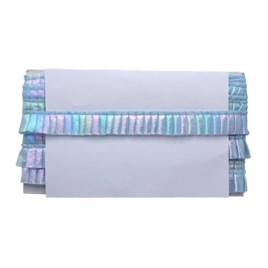 Folded fabric with colorful ruffled trim on a white background