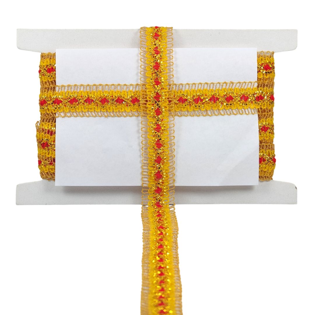 Roll of yellow ribbon with red embellishments on a white background