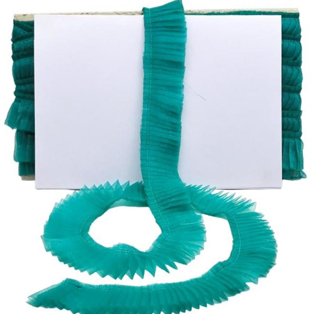 Teal ruffled ribbon on a white background
