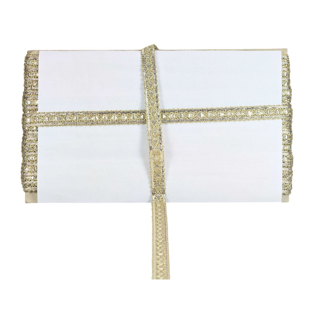 White clutch bag with gold decorative trim on a white background