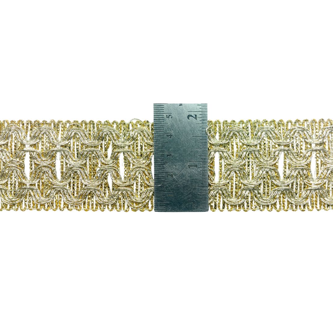 Decorative gold and silver braided trim with a ruler for scale on a white background