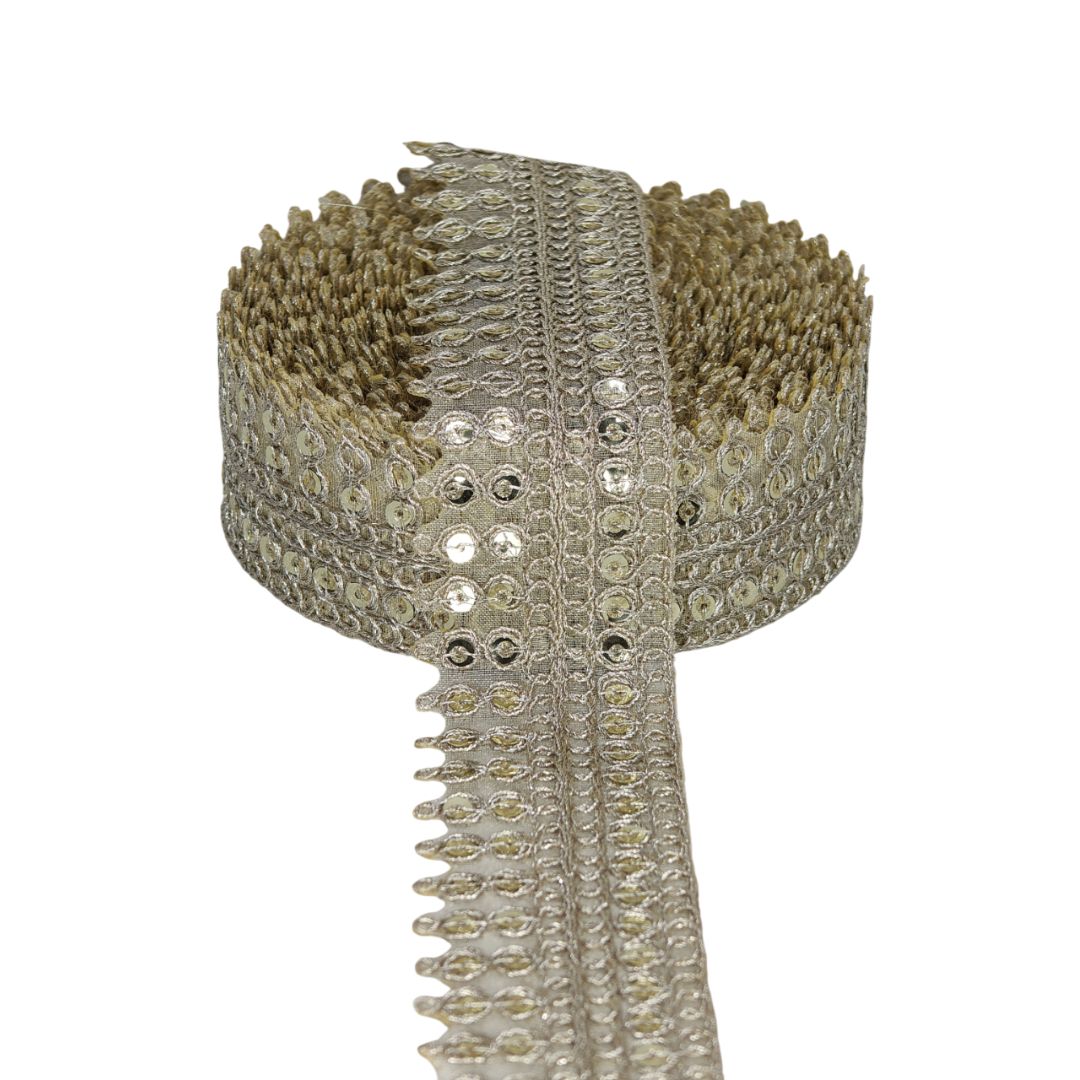 Decorative ribbon with metallic embellishments on a white background