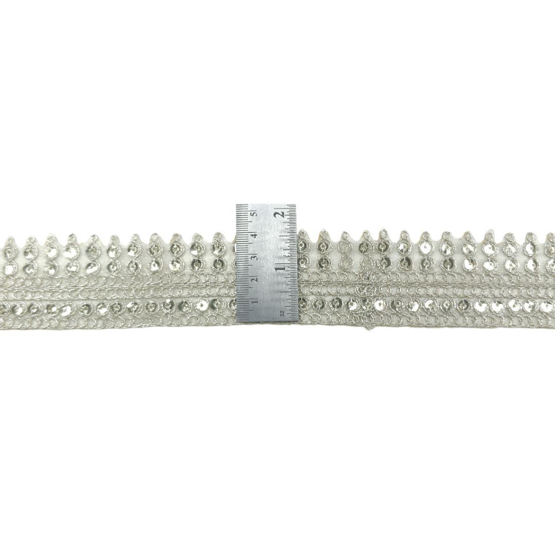 Silver decorative trim with a ruler for scale on a white background