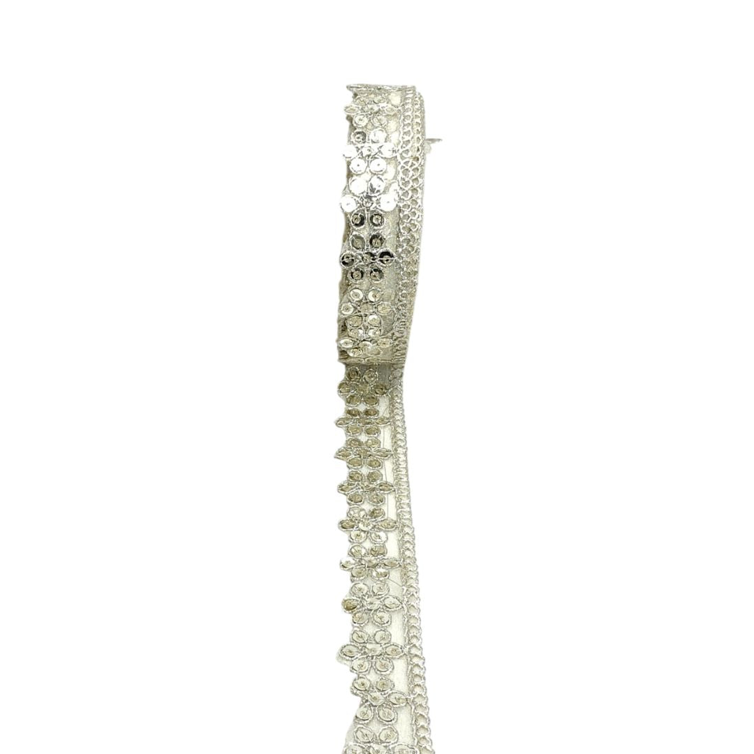 Silver tiara with intricate design on a white background