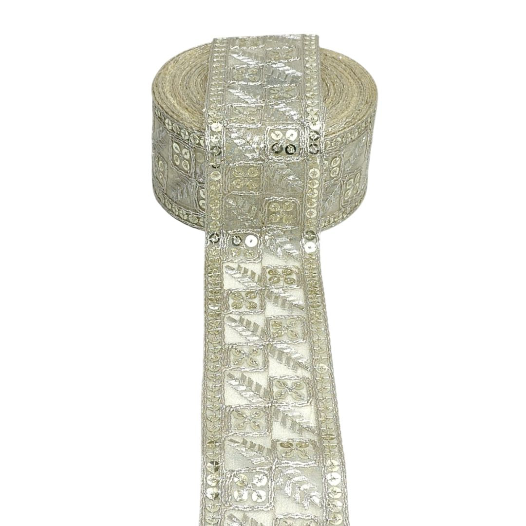 Decorative ribbon with sequins and beads on a white background