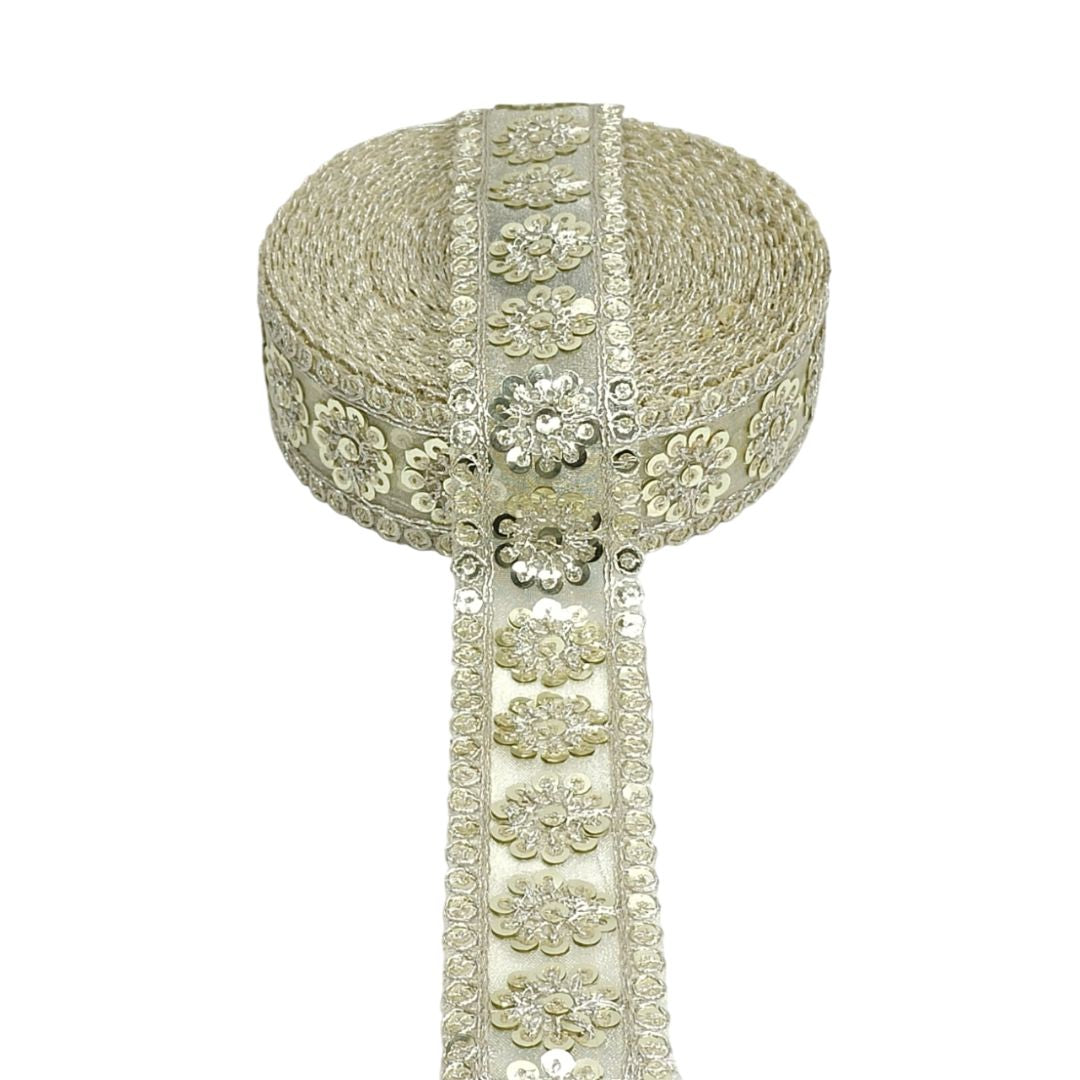 Decorative ribbon with floral patterns and sequins on a white background