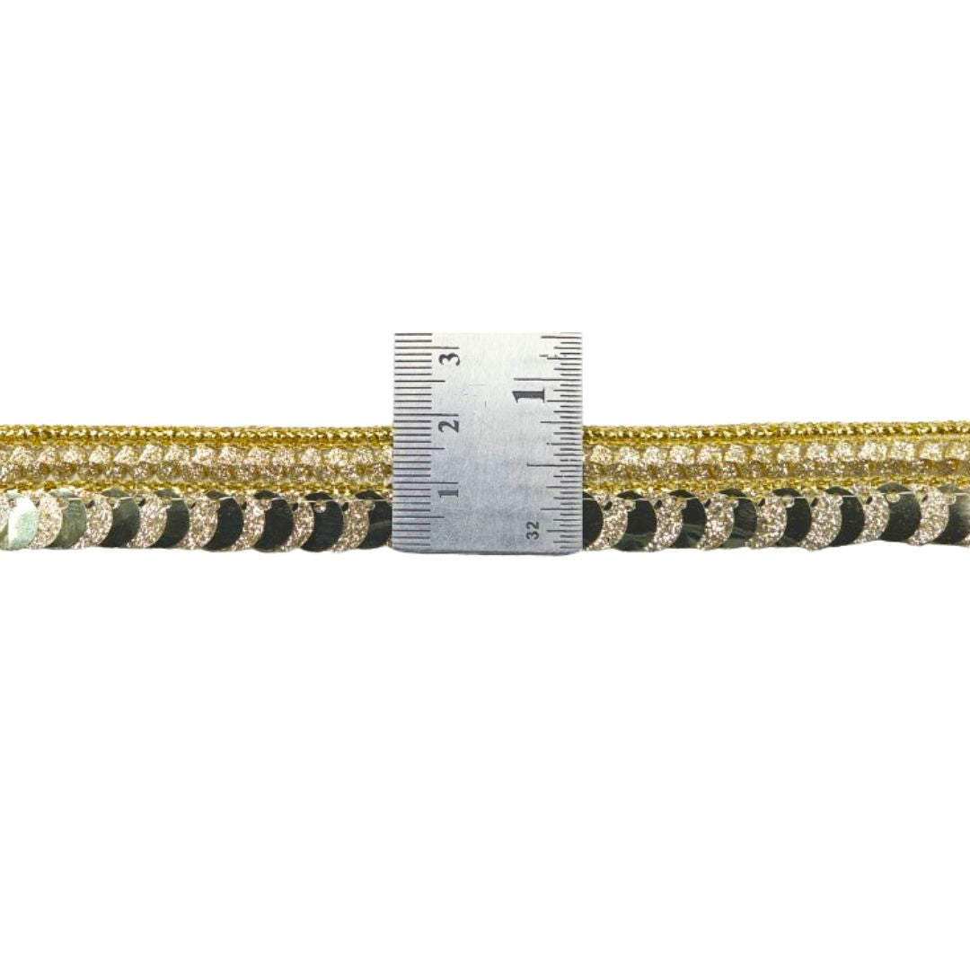 Gold and black braided cable with a ruler for scale on a white background