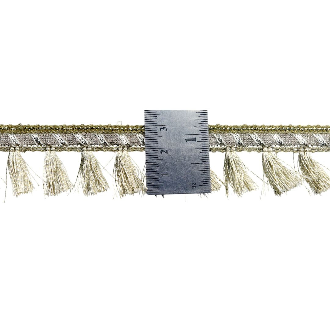 Textured trim with tassels and a ruler for scale on a white background