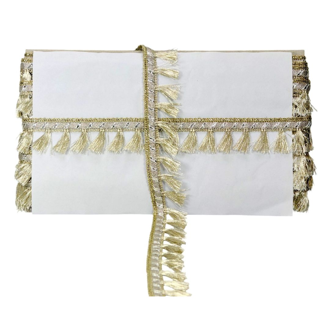 White clutch bag with gold fringe and embellishments on a white background