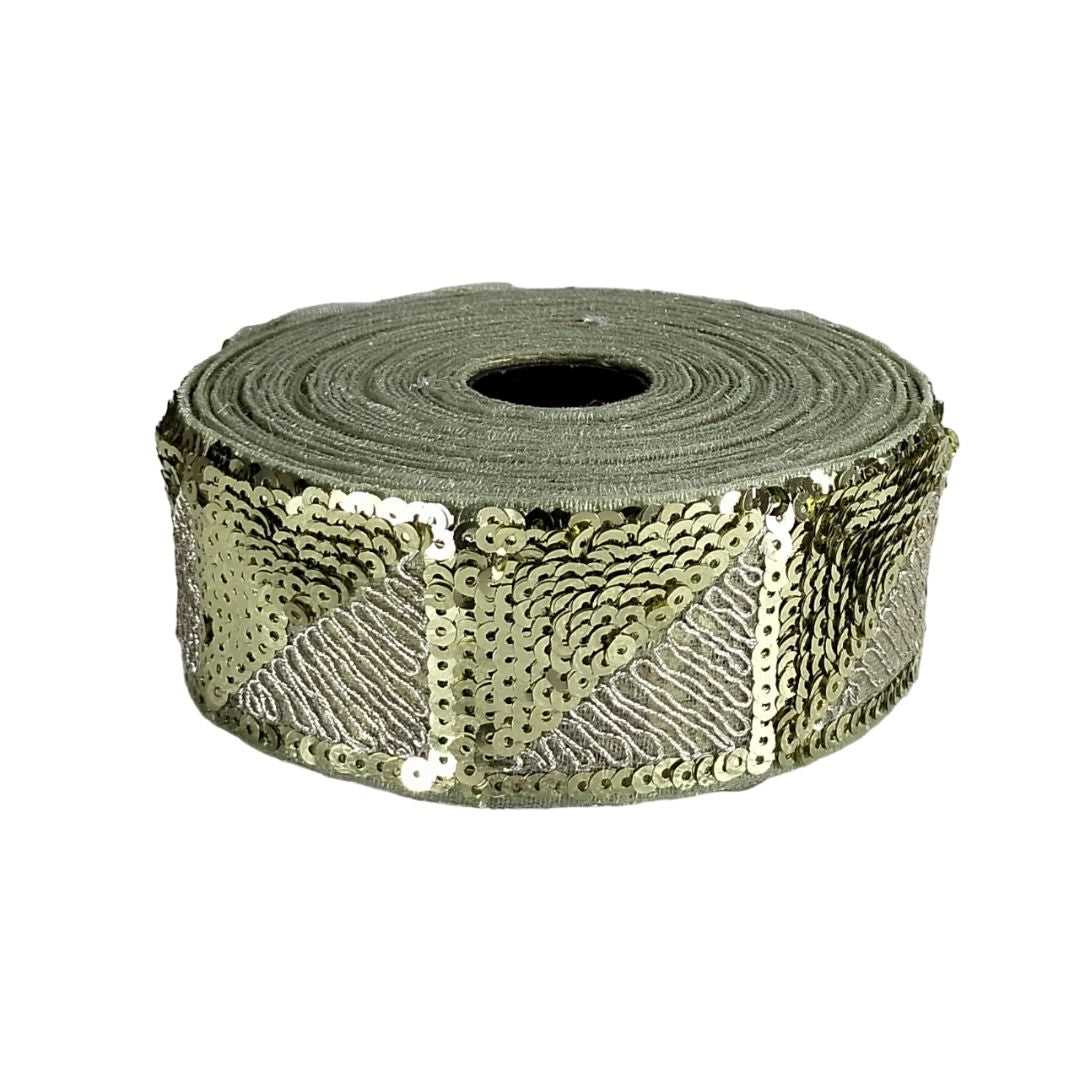 Roll of gold sequin ribbon on a white background