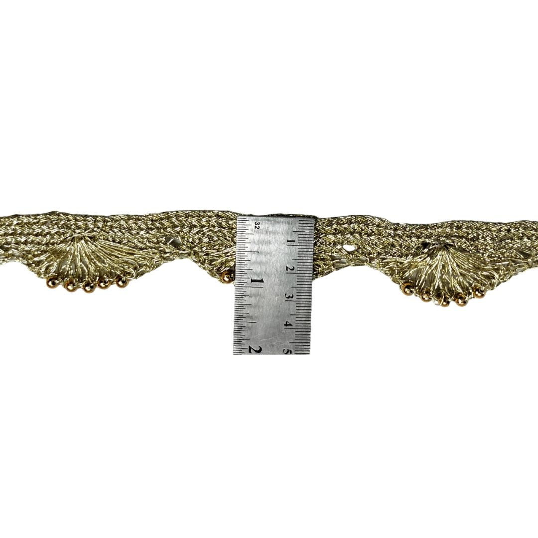 Decorative lace trim with a ruler for scale on a white background