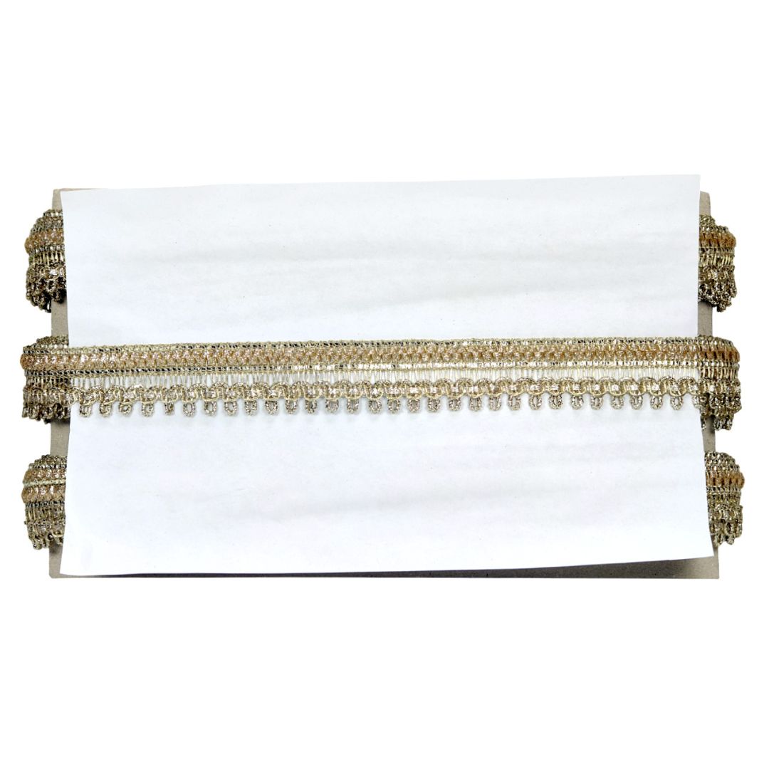 White clutch with gold beaded trim on a white background