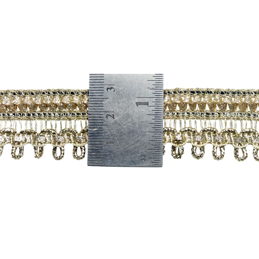 Gold fringe trim with a ruler for measurement on a white background