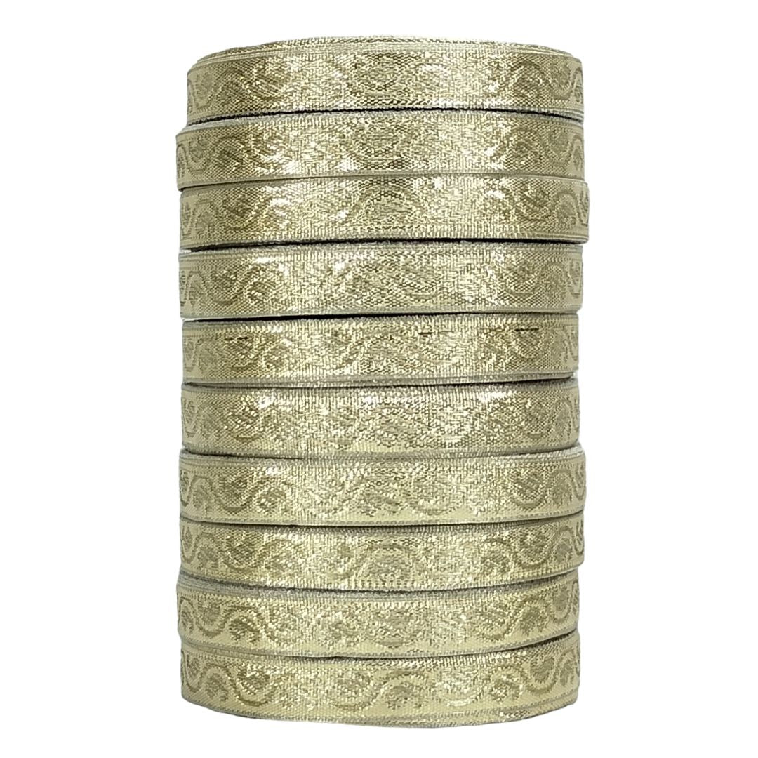 Stack of gold ribbons with a paisley pattern on a white background