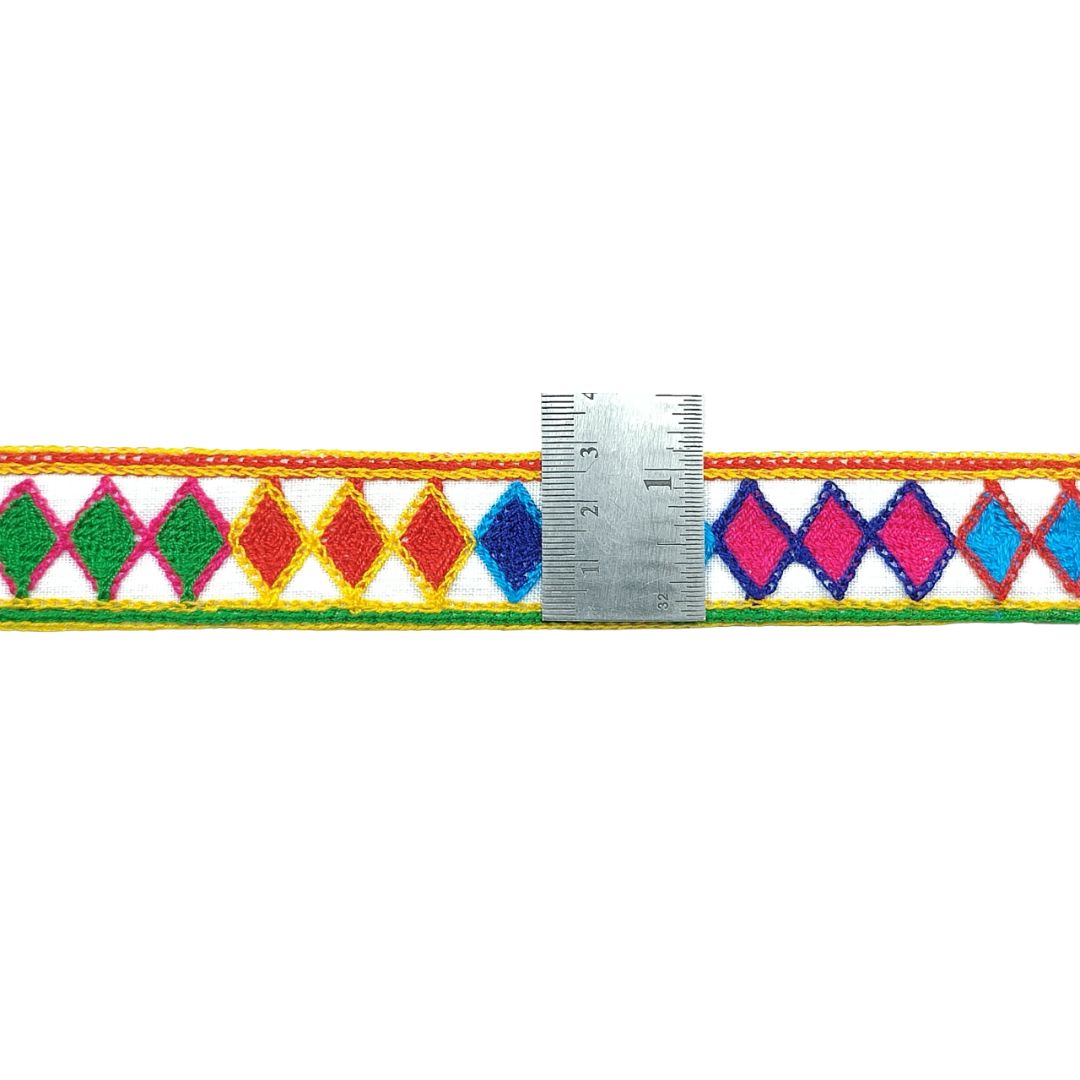 Colorful diamond-patterned belt with a ruler for scale on a white background