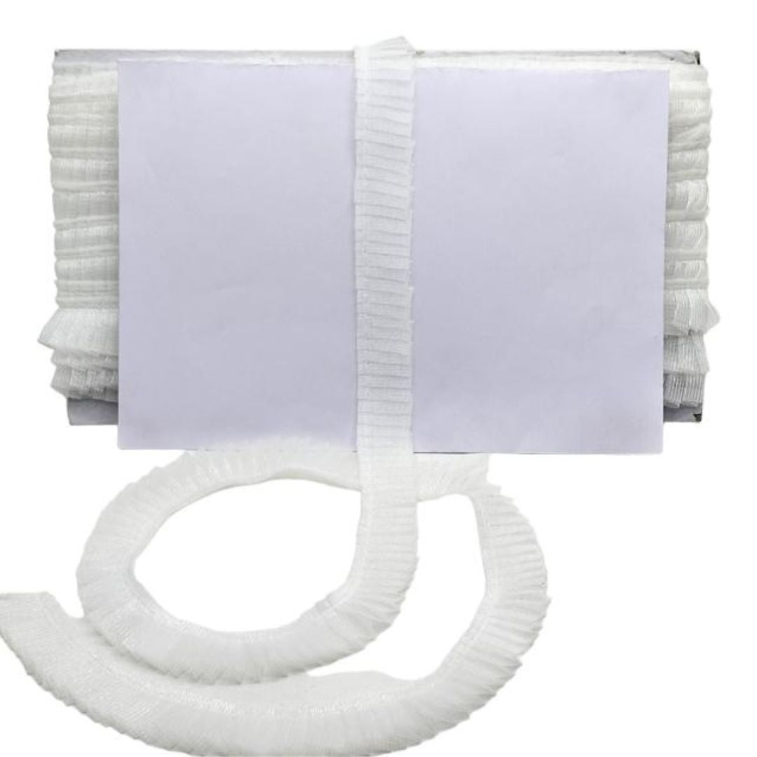 Stack of white towels with a roll of toilet paper on a white background