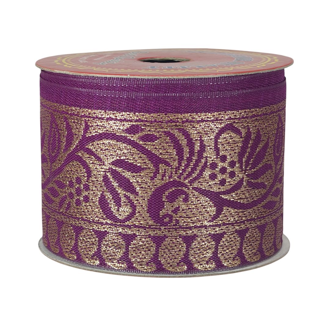 Roll of decorative ribbon with purple and gold pattern on a white background