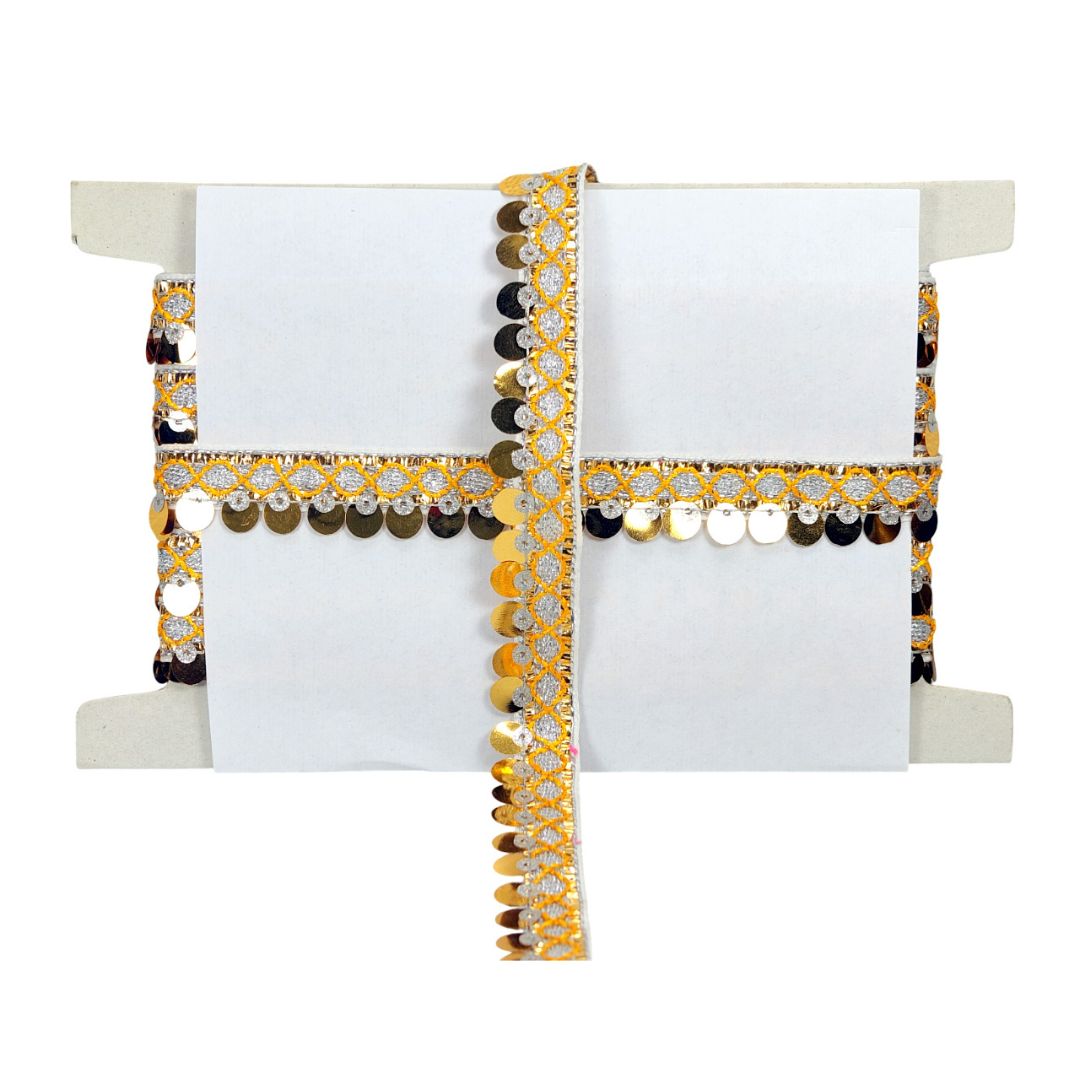Decorative white napkin with gold and black embellishments on a white background