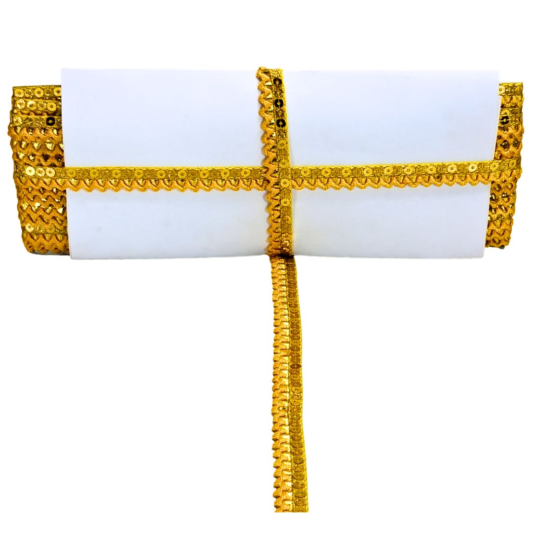 White clutch with gold sequin detailing on a white background