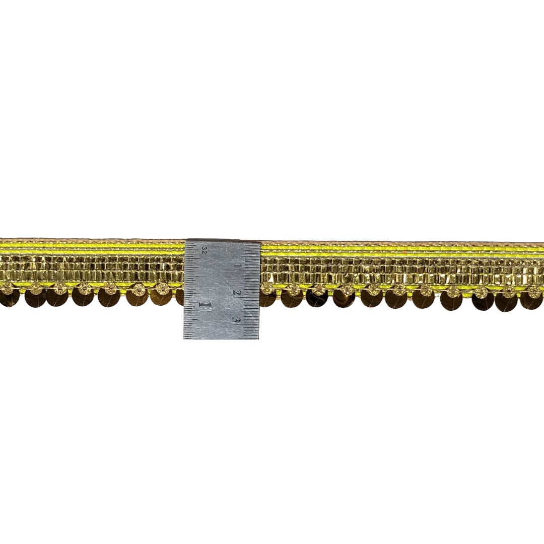 Gold decorative trim with a ruler for scale on a white background