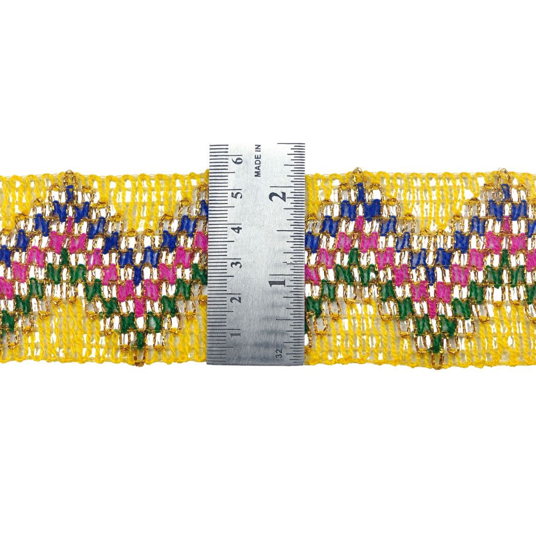 Multicolored beaded trim with a ruler for scale on a white background