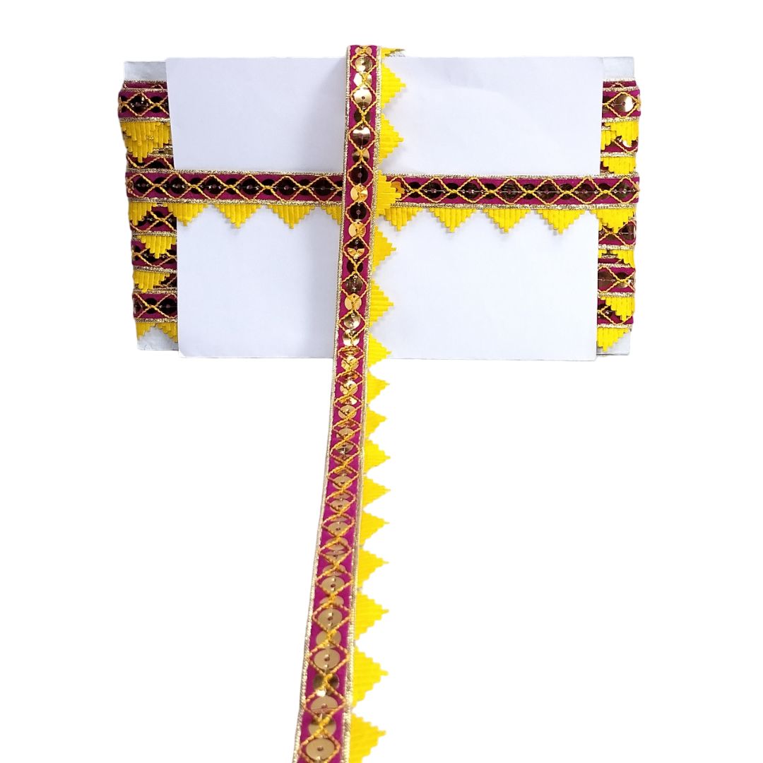Decorative headband with gold and red patterns on a white background