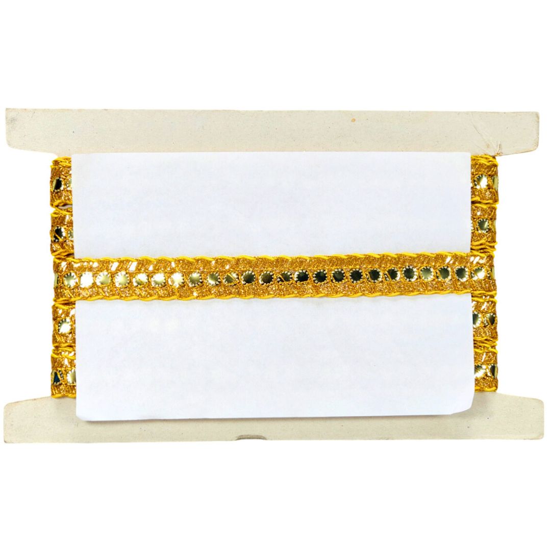 White spool of thread with gold and black pattern on a beige stand