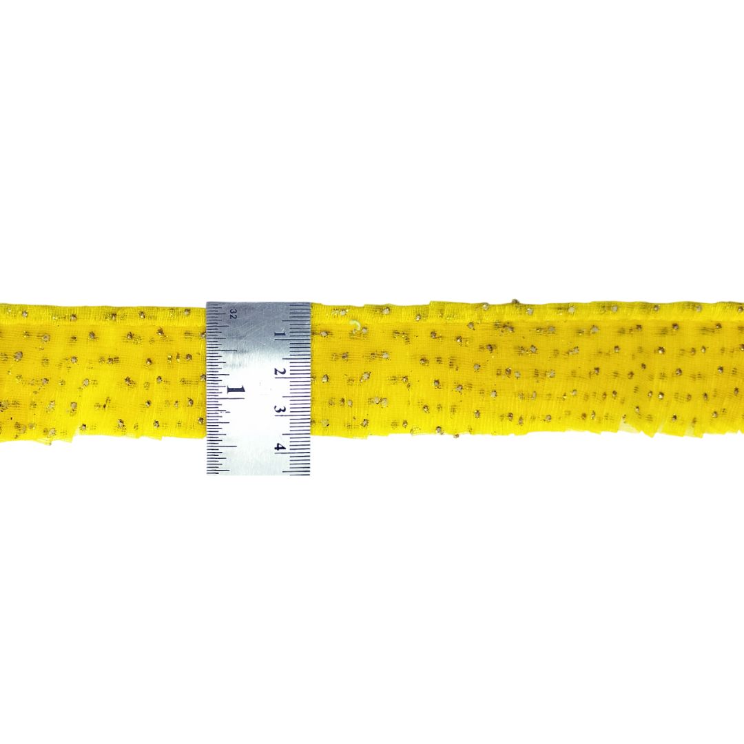 Yellow belt with a ruler for scale on a white background