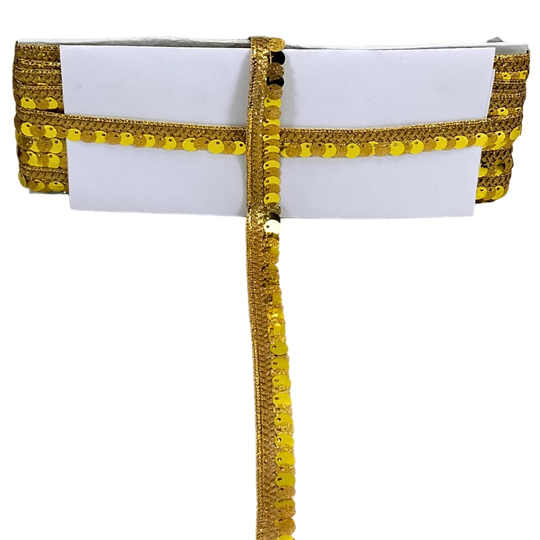 White clutch with gold and yellow decorative trim on a white background