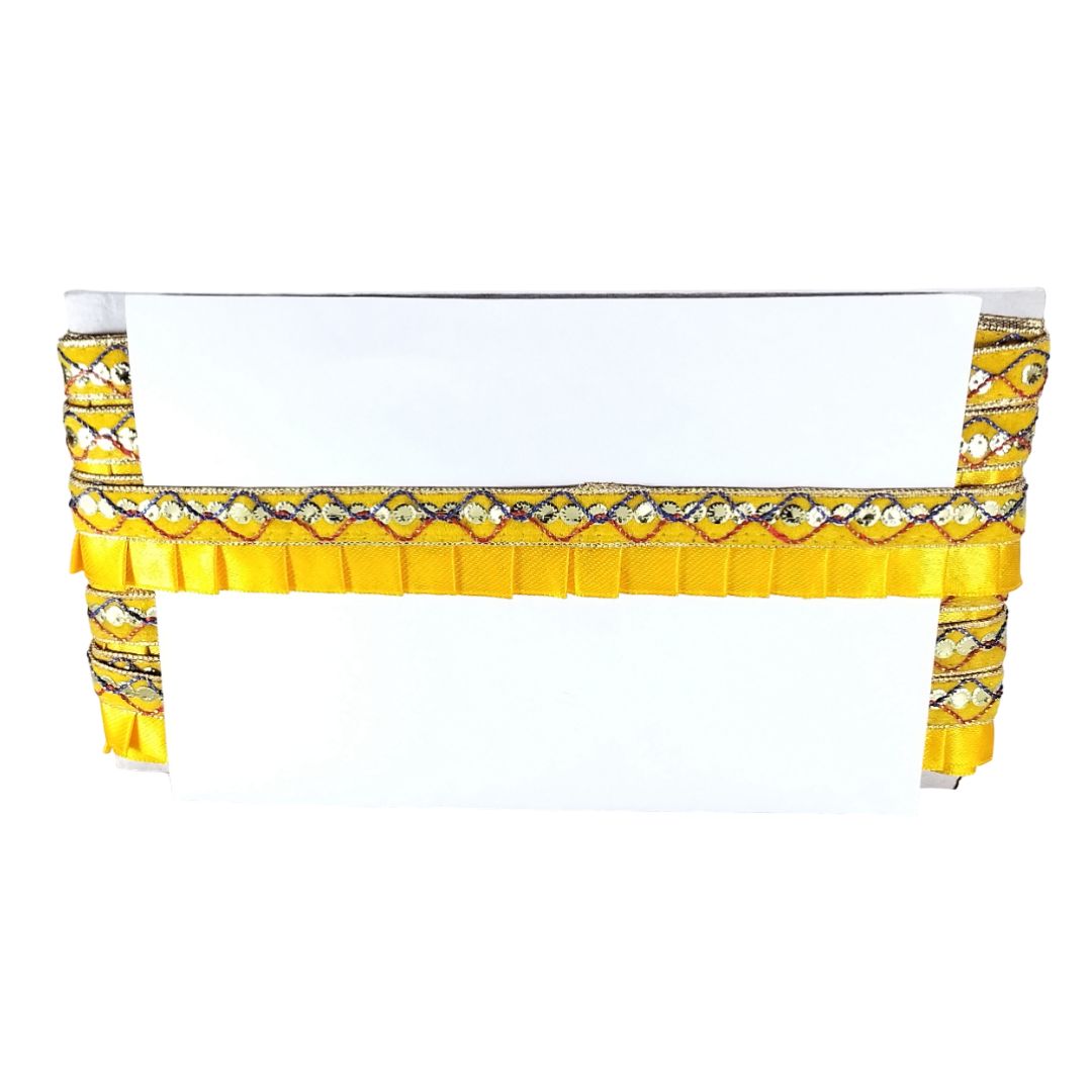 White table with yellow and black patterned tablecloth on a white background