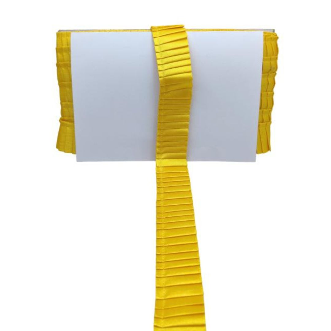 Yellow pleated ribbon on a white background