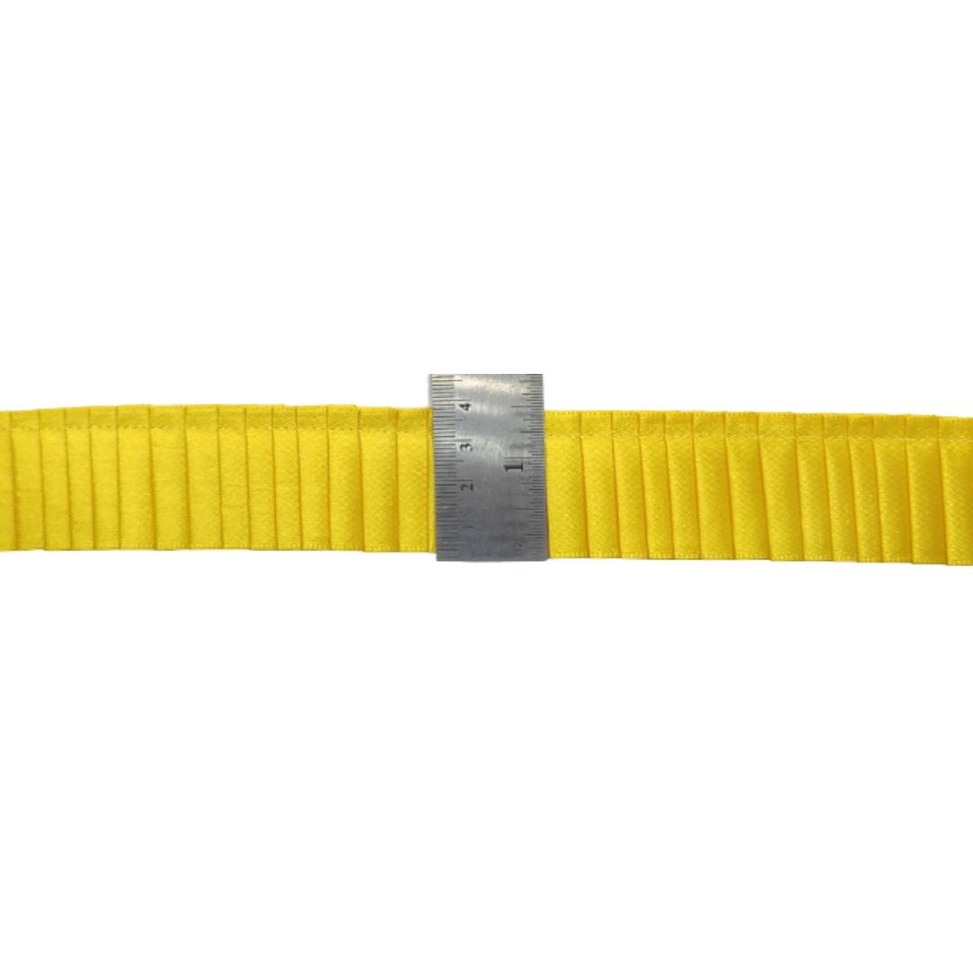 Yellow belt with a metal ruler on a white background