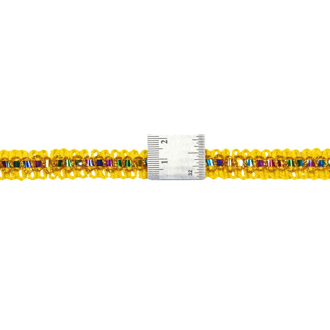 Multicolored beaded bracelet with a ruler for scale on a white background