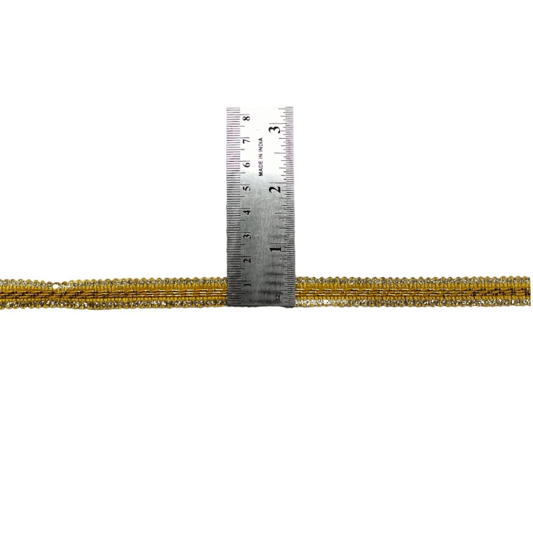 Gold beaded cord with a ruler for measurement on a white background