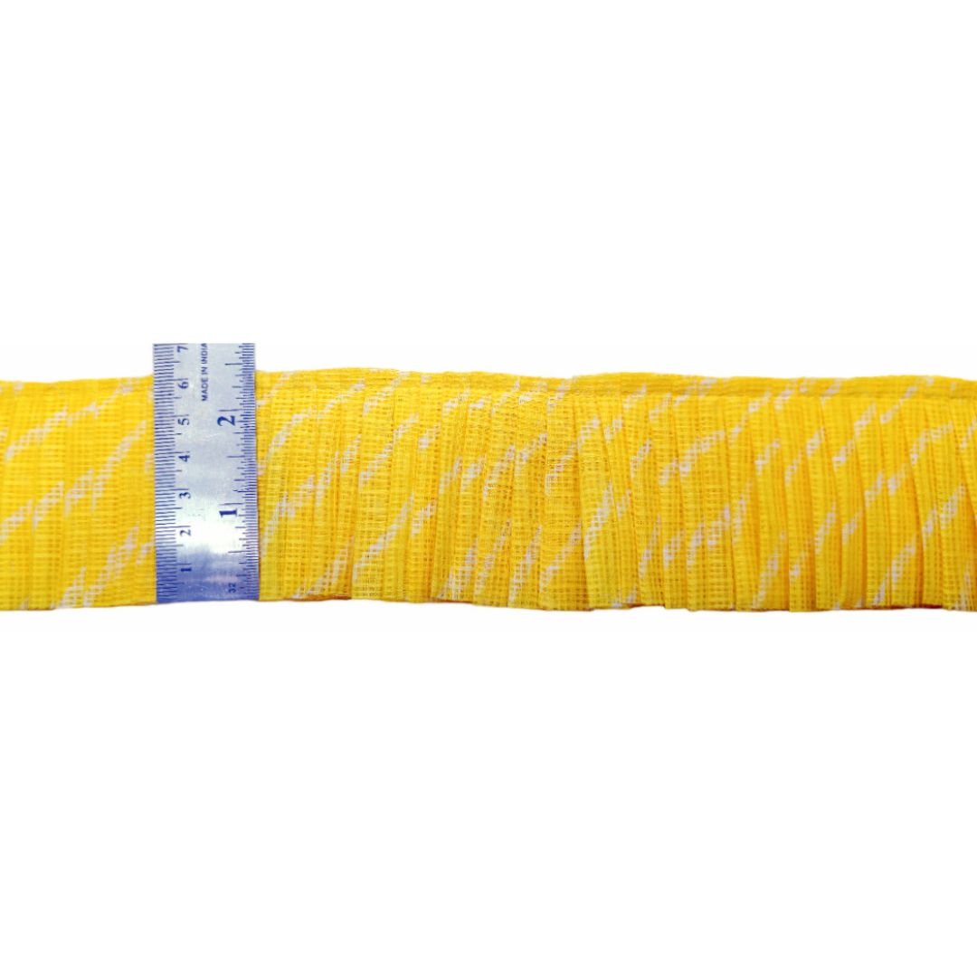 Yellow webbing with a ruler for scale on a white background