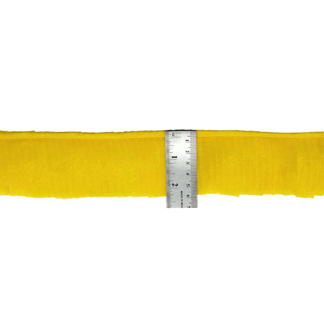 Yellow belt with a ruler for size reference on a white background