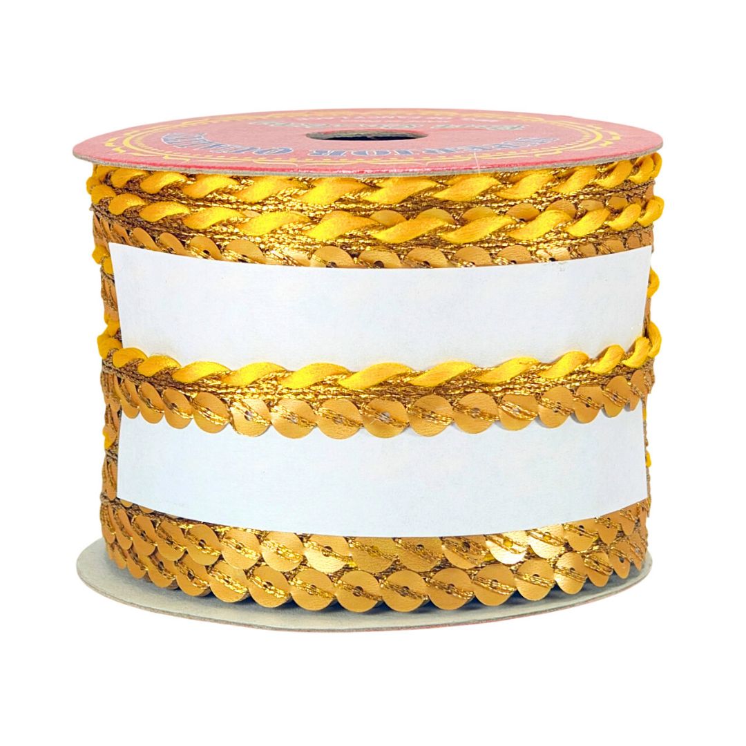 Spool of gold sequin ribbon on a white background