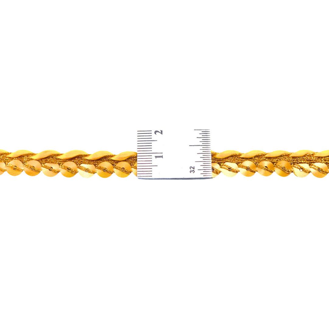 Gold chain with a ruler for size reference on a white background