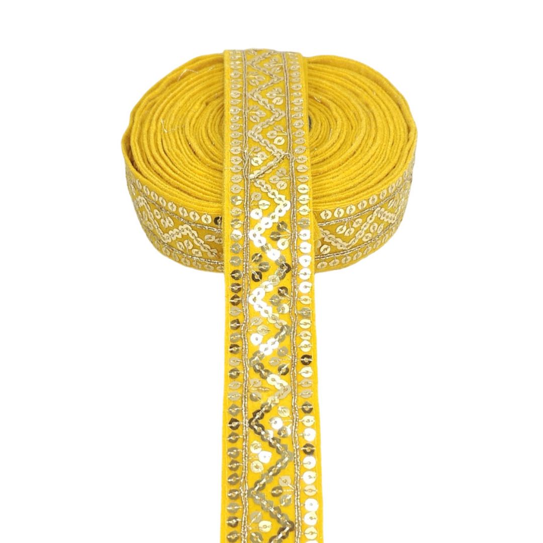 Yellow ribbon with decorative gold pattern on a white background