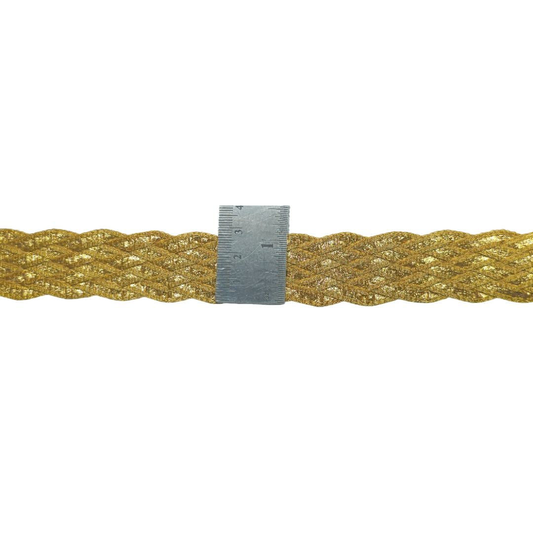 Gold braided cord with a ruler for scale on a white background
