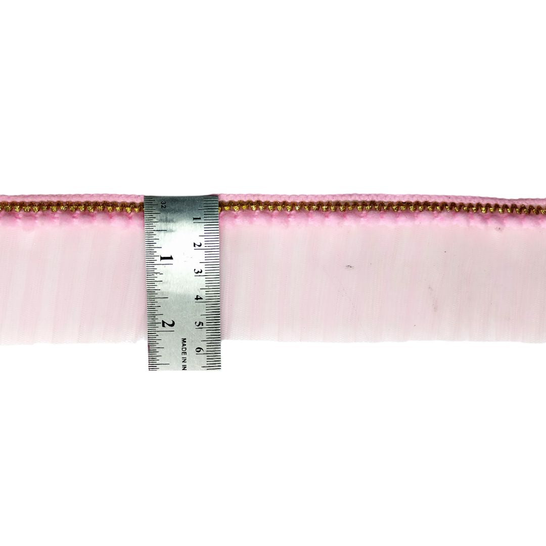 Pink ribbon with a ruler for measurement on a white background