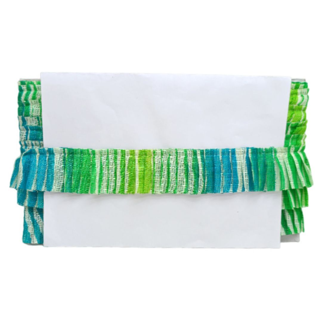 Folded fabric with green and blue striped pattern on a white background