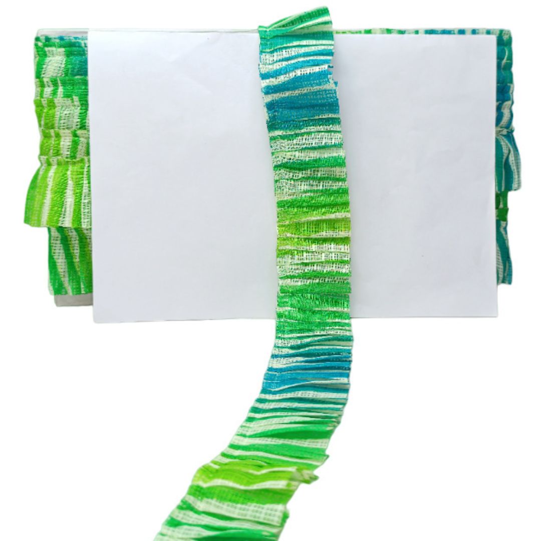 Green and blue striped fabric on a white background