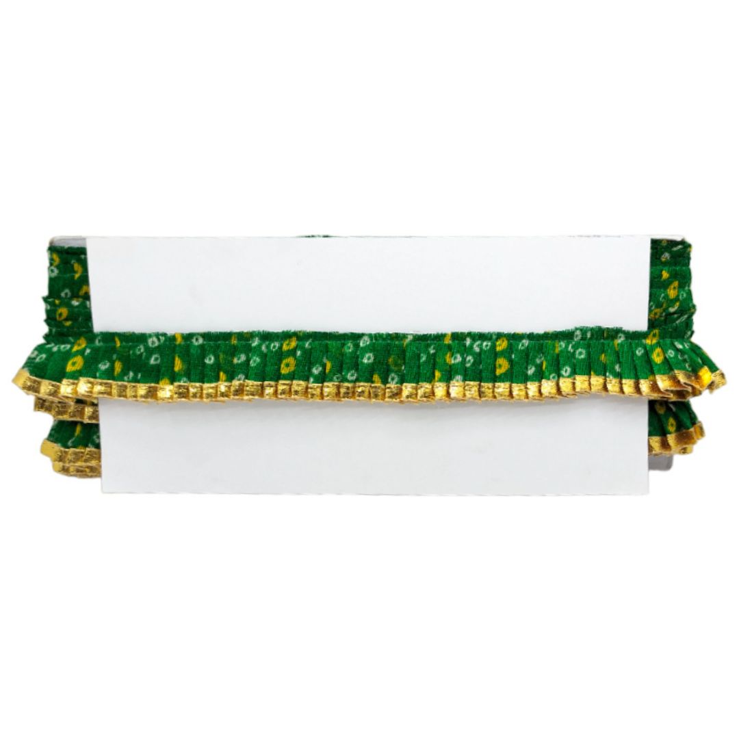 Green and gold decorative item on a white background