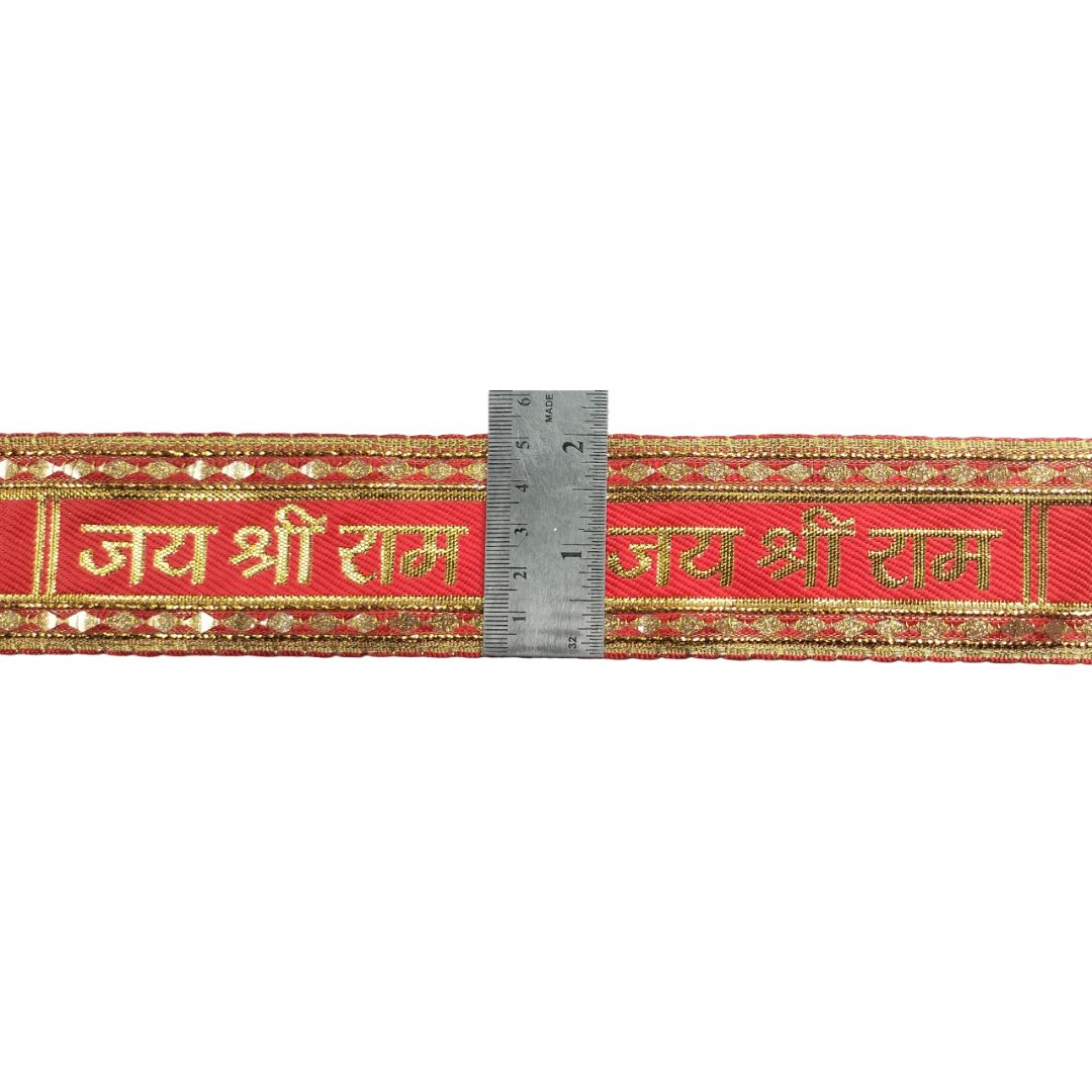 Red ribbon with gold text and decorative patterns, featuring a ruler for scale.