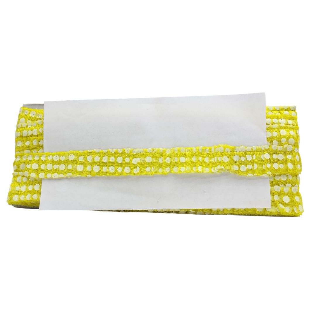 Yellow fabric with white polka dots and a white center on a white background