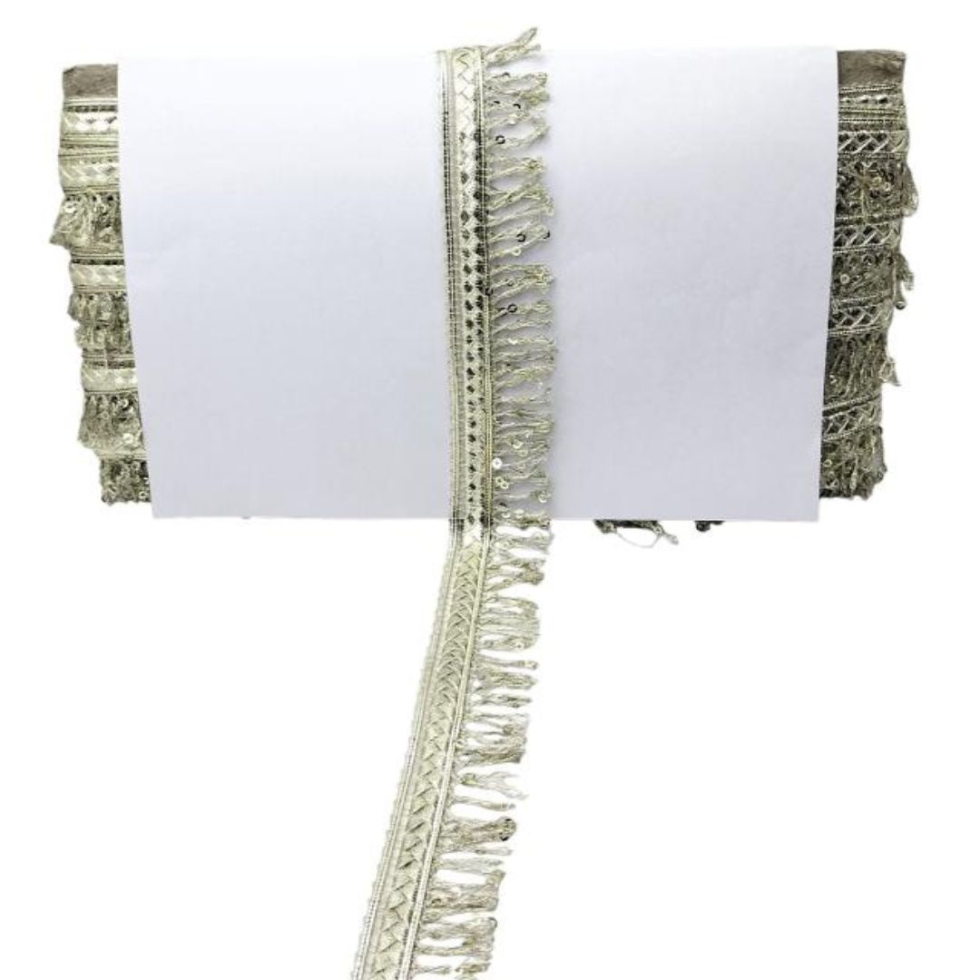 Textile sample with fringe details on a white background