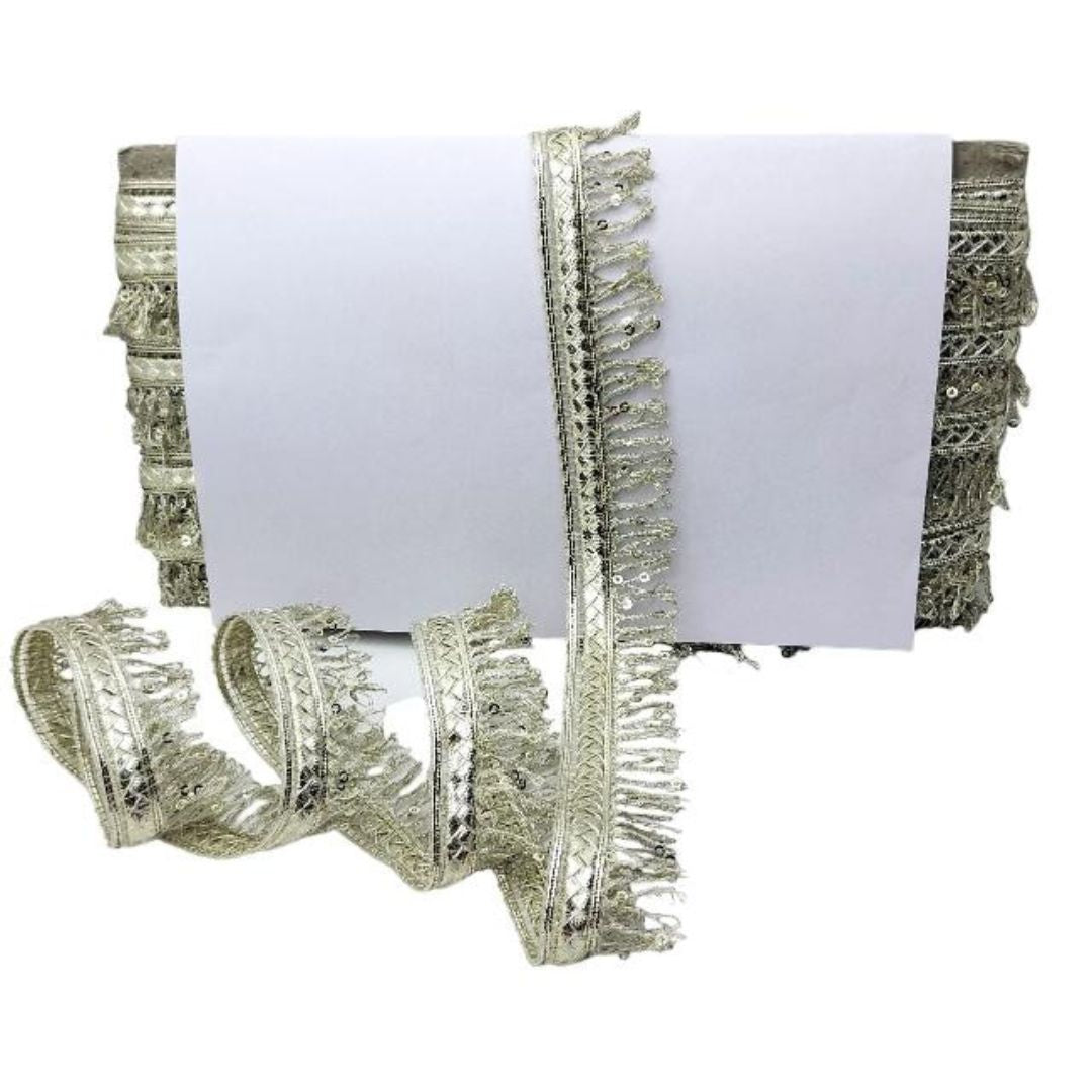 Decorative silver fringe trim on a white background