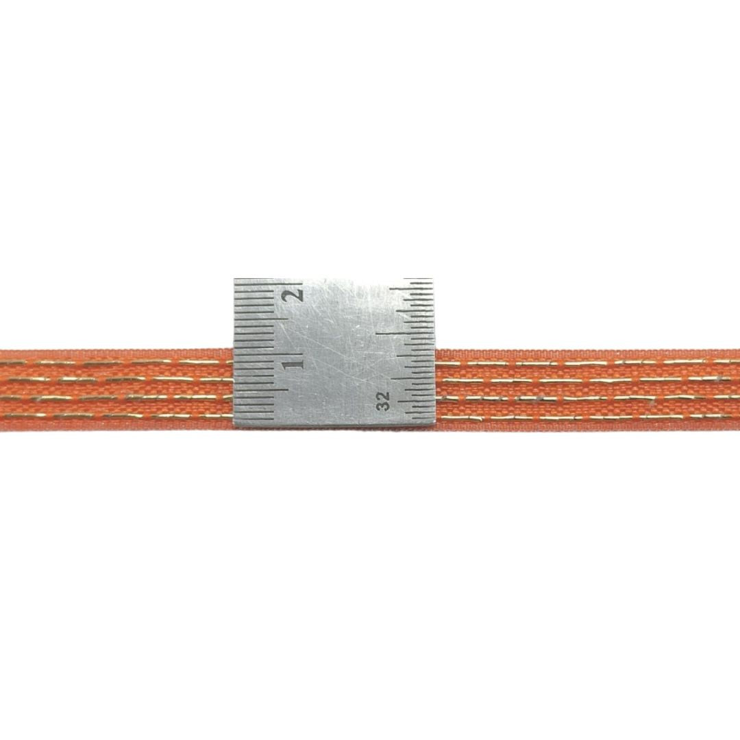 Metallic tape measure with orange thread on a white background