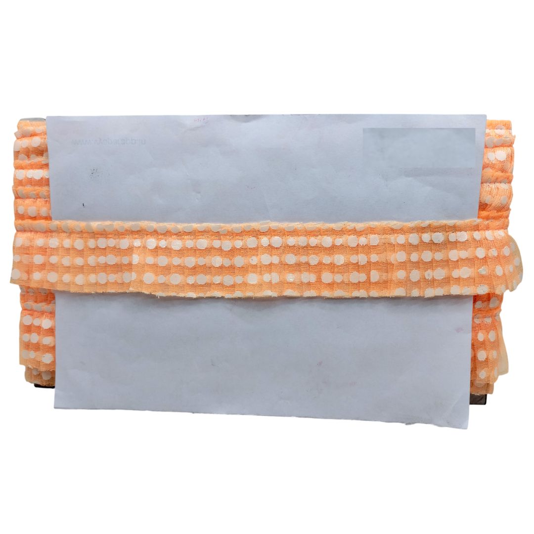 Folded fabric with orange and white pattern on a white background